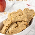 Homemade bone-shaped apple dog treats in a bowl.