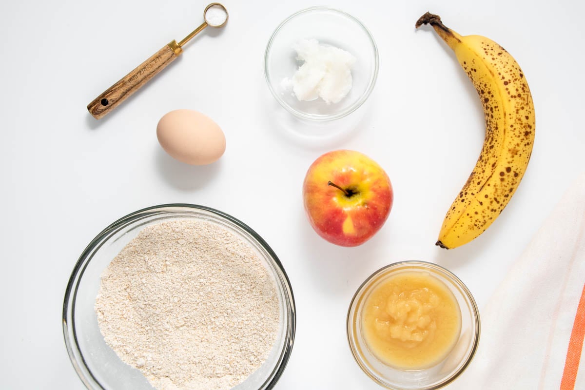 Homemade apple pupcakes ingredients on a marble surface.