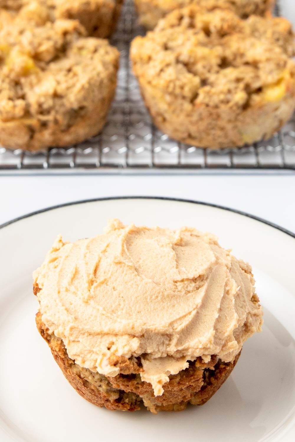 Homemade apple pupcakes on a plate and wire rack.