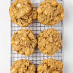 Unfrosted apple pupcakes on a wire rack.