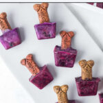 Blueberry popsicles for dogs scattered on a platter.