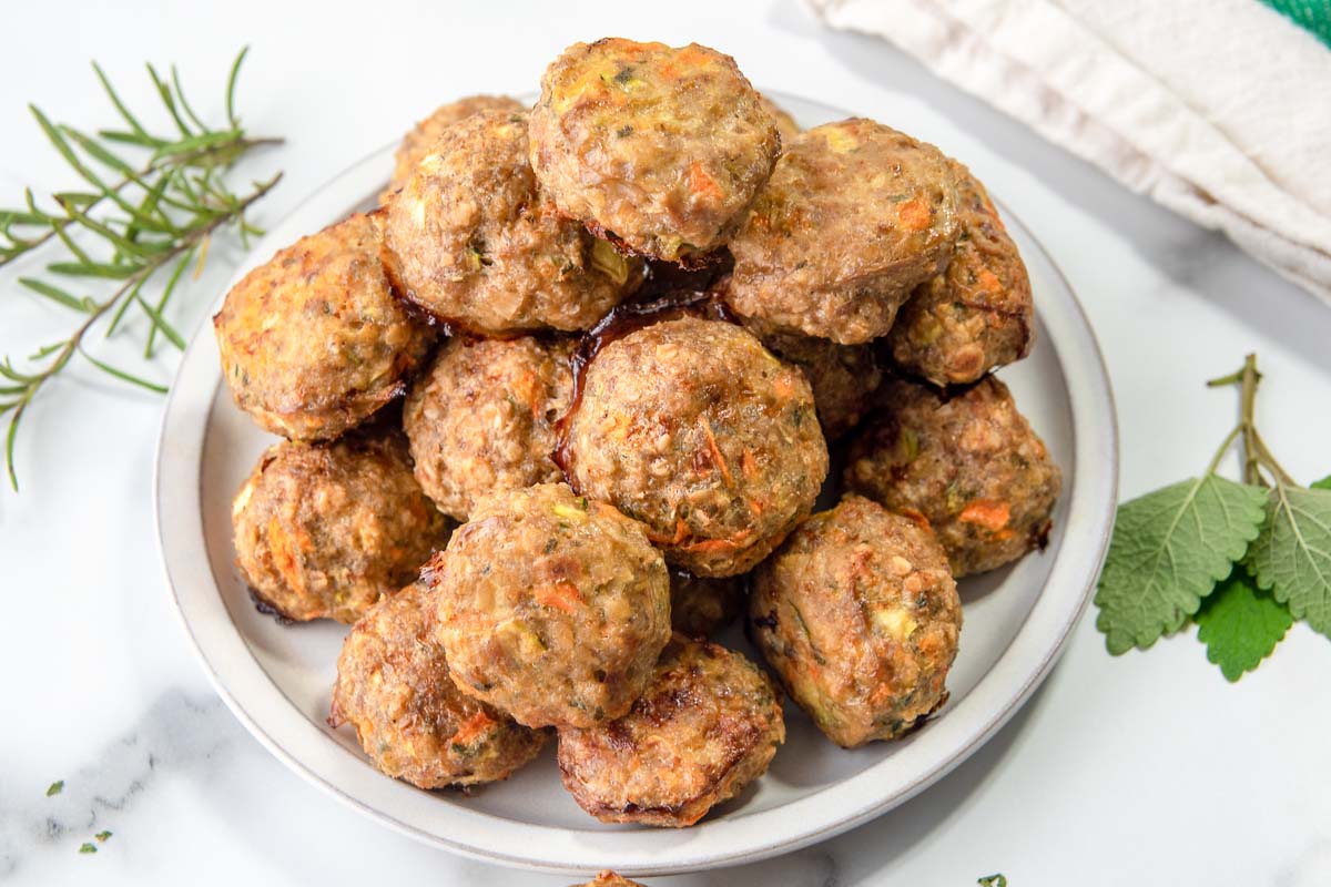 Homemade chicken meatballs for dogs on a plate.