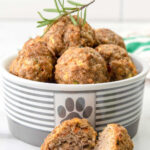 Homemade chicken meatballs for dogs in a small dog bowl.