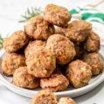 Homemade chicken meatballs for dogs piled on a plate.