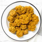Homemade peanut butter pumpkin dog treats in a bowl.
