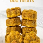 Two stacks of paw-shaped peanut butter pumpkin dog treats.