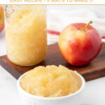 Homemade applesauce for dogs in a bowl and jar and an apple.