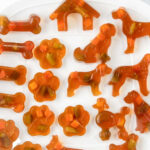 Homemade gelatin dog gummy treats on a platter.