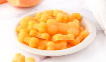 Homemade frozen cantaloupe dog treats in a small bowl.