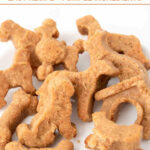 Homemade almond flour dog treats in several shapes on a plate.