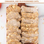 Homemade paw and bone shaped apple cinnamon dog treats on a serving board.