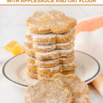A stack of paw-shaped homemade butternut squash dog treats on a small plate.