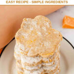 A stack of paw shaped homemade butternut squash dog treats and a butternut squash.