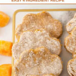 Homemade paw shaped butternut squash dog treats on a serving board.