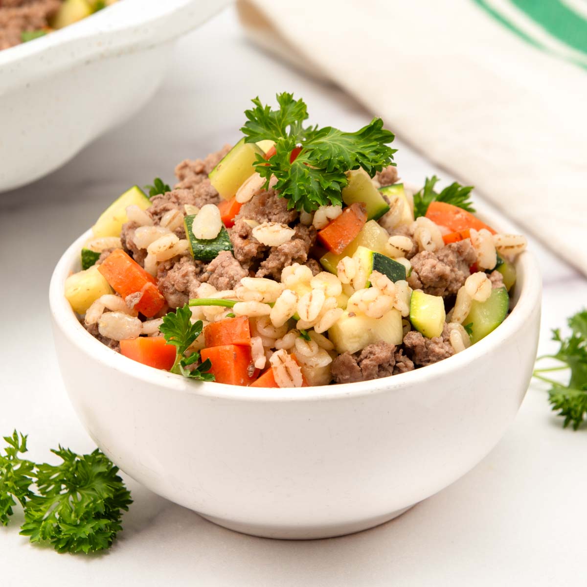 Homemade ground lamb dog food in a bowl.