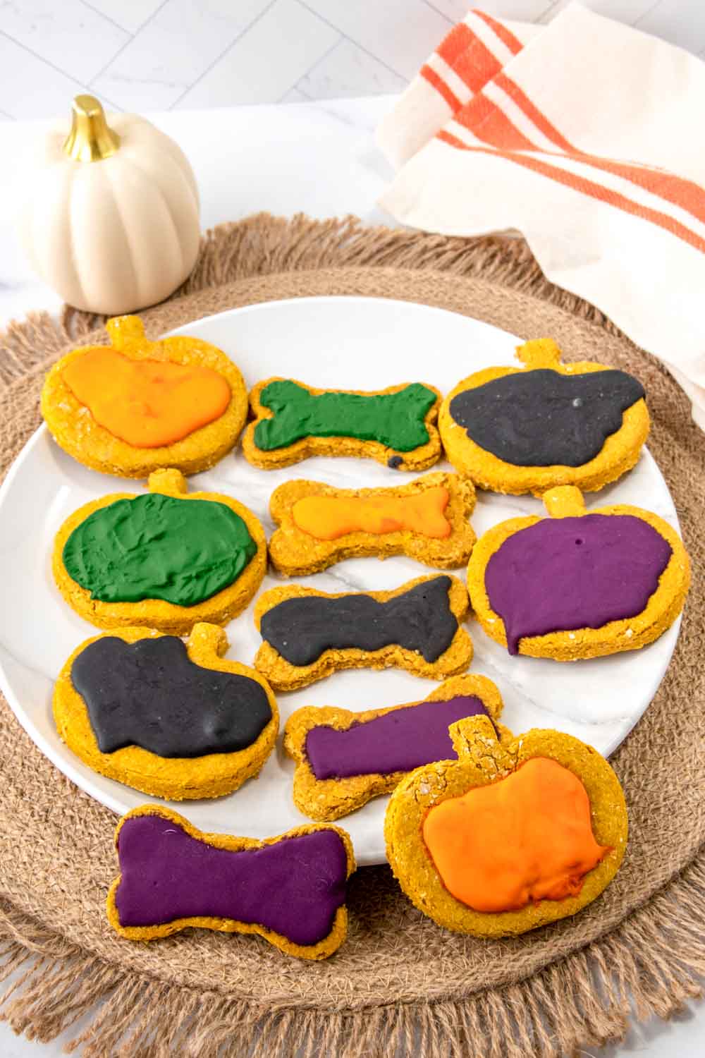 Homemade Halloween dog treats with icing on a platter.