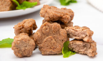 Homemade ground lamb dog treats in paw shapes.