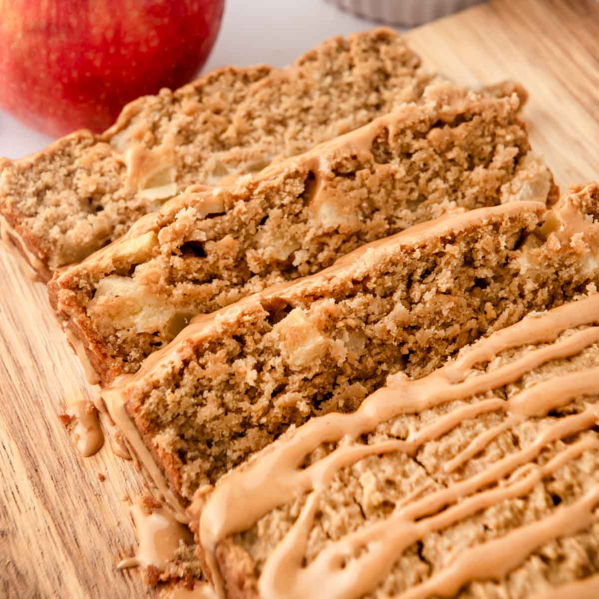 Homemade peanut butter apple cake for dogs with peanut butter drizzle on top.