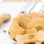 Homemade pumpkin seed dog treats on a plate and ground pumpkin seeds in a spoon.