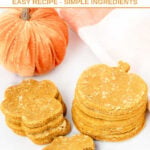 Stacks of paw and pumpkin-shaped homemade pumpkin spice dog treats.
