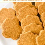 Homemade paw-shaped sardine dog treats piled on a plate.