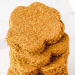 Homemade paw-shaped sardine dog treats in a stack.