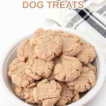 Homemade snickerdoodle dog treats piled in a bowl and one beside it.