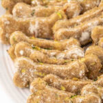 A bunch of homemade zucchini dog treats on a plate.