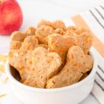 Homemade apple cheddar dog treats in a bowl.