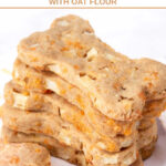 A stack of homemade bone-shaped apple cheddar dog treats.