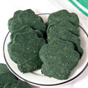 Homemade spirulina dog treats on a plate.