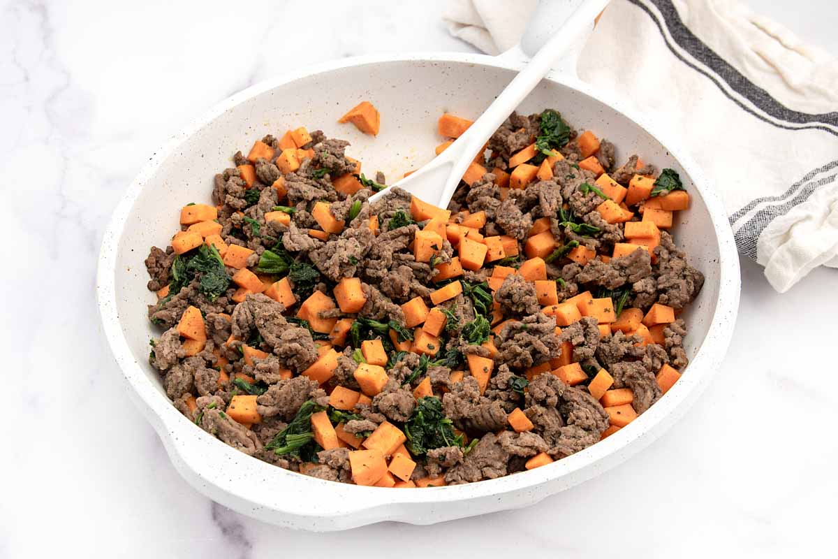 Homemade beef and sweet potato dog food in a skillet.
