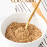 Homemade dog food seasoning and a spoon in a small bowl.
