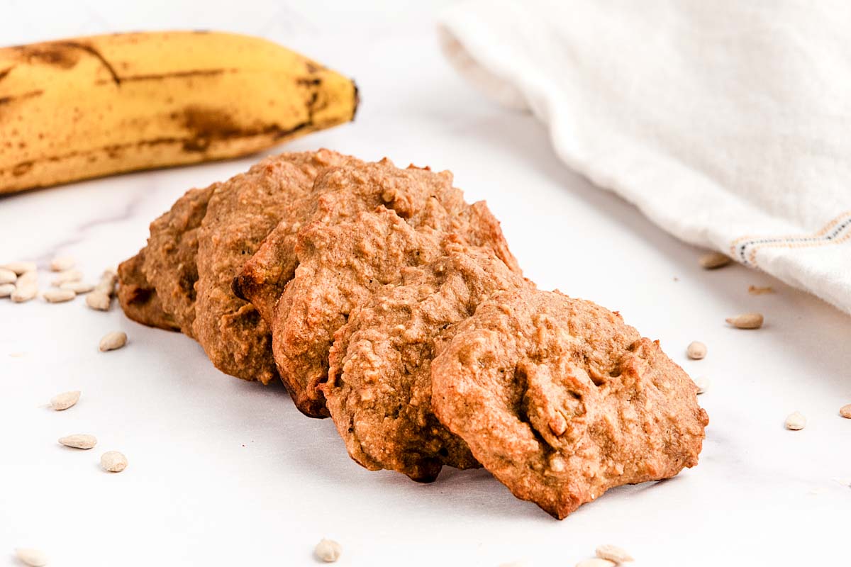 Homemade sunflower seed dog treats on a marble surface.