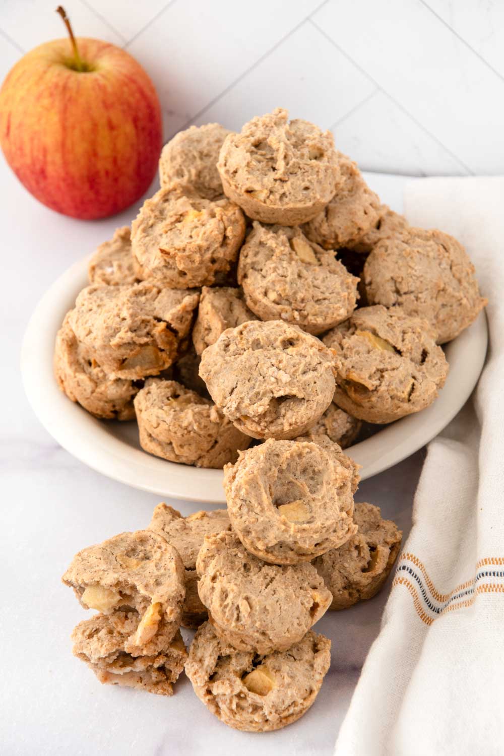 Homemade apple muffins for dogs on and in front of a plate.