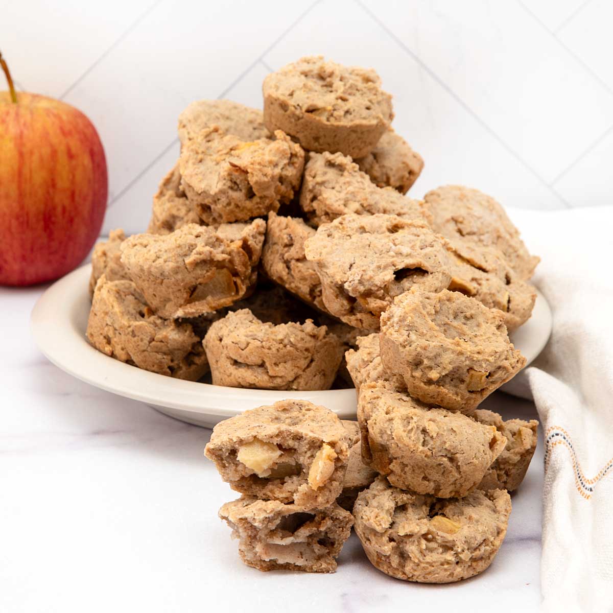 Homemade apple muffins for dogs and an apple.