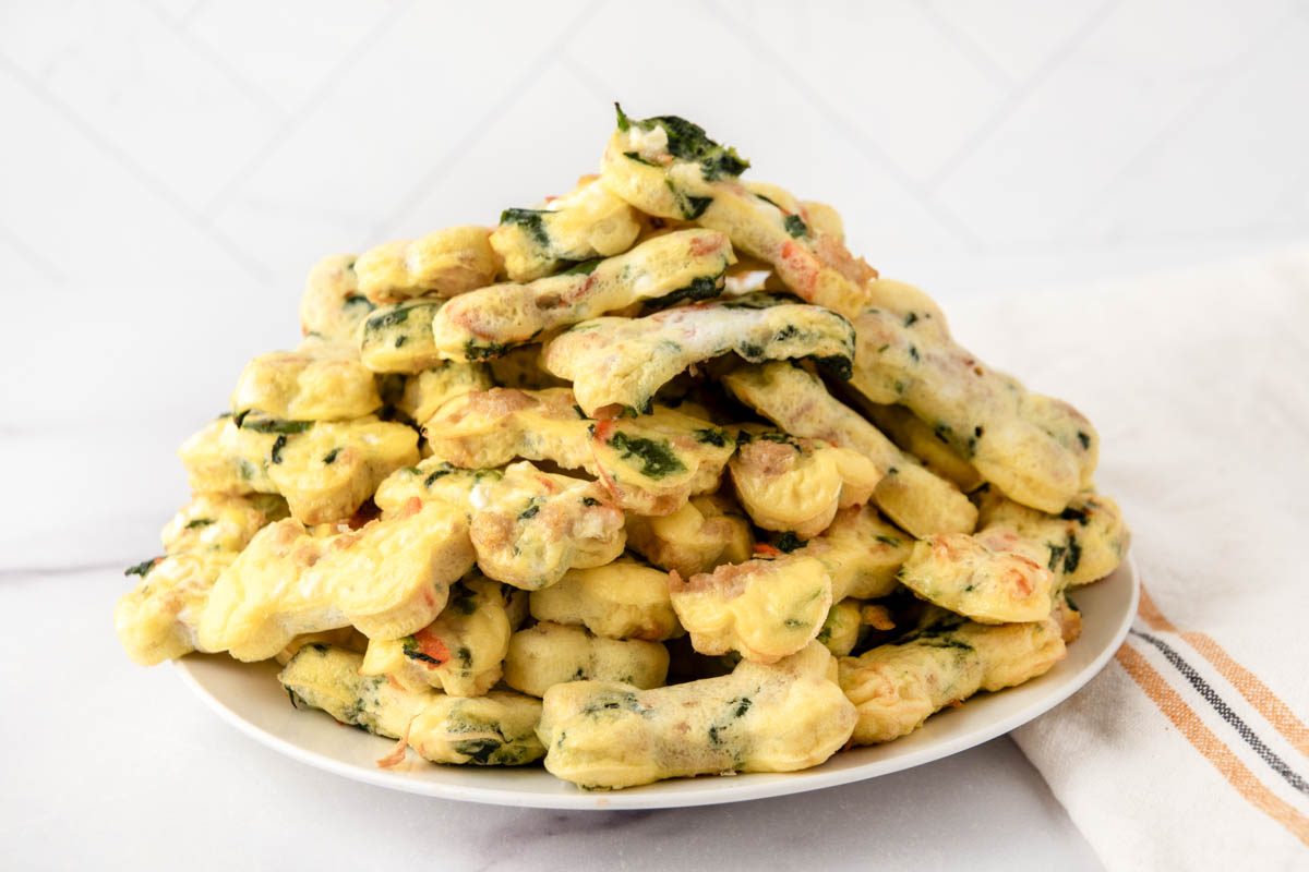 Homemade egg bites for dogs piled on a plate.