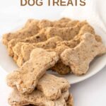 Homemade mackerel dog treats on a small plate and stacked beside it.