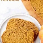 Slices of homemade pumpkin bread for dogs on a plate and wood cutting board.