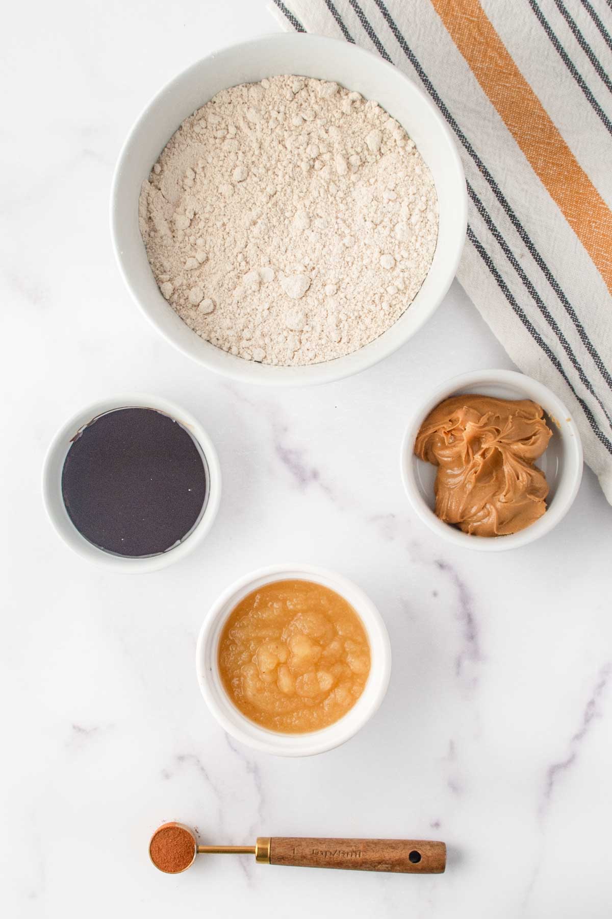Homemade molasses dog treats ingredients on a marble surface.