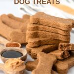 Homemade molasses dog treats in a stack and some in front and behind it.