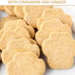 Homemade paw-shaped acorn squash dog treats on a marble surface.