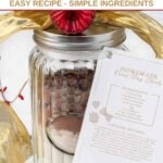 Homemade dog treat mix in a jar with a recipe card attached to it.