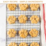 Homemade paw-shaped goat milk dog treats on a wire rack.