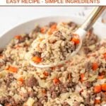Homemade ground lamb and barley dog food in a skillet and on a serving spoon above it.