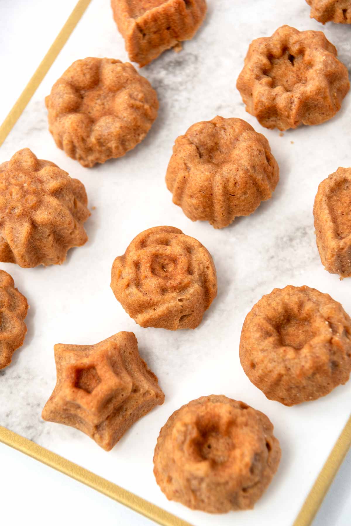 Honey almond tea cakes for dogs in various bundt shapes on a platter.