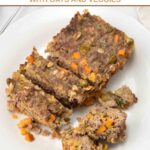 Homemade meatloaf for dogs on a plate and partially sliced and cut into small pieces.