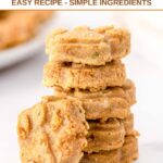 A stack of homemade paw-shaped salmon and sweet potato dog treats.