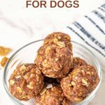 Homemade satin balls for dogs in a small glass bowl on a marble surface.