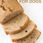 A loaf of homemade banana bread for dogs with three slices cut from it.